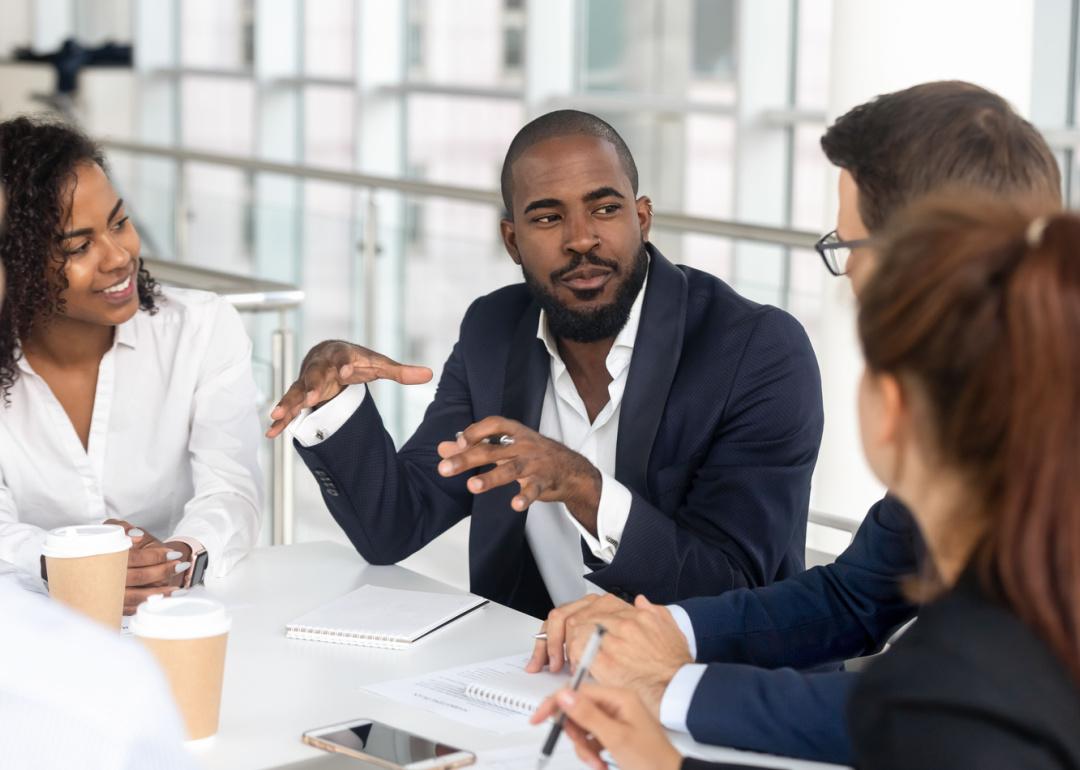 CEO leading corporate team in boardroom.