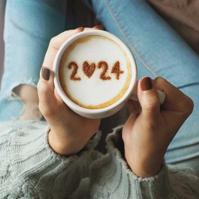 overhead view of a coffee cup with the number "2024" displayed on the foam for the new year