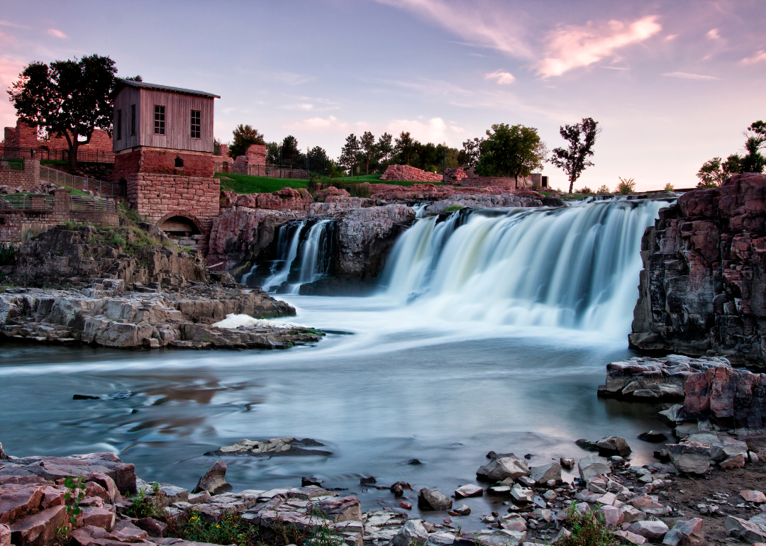A waterfall in Sioux Falls at sunset.