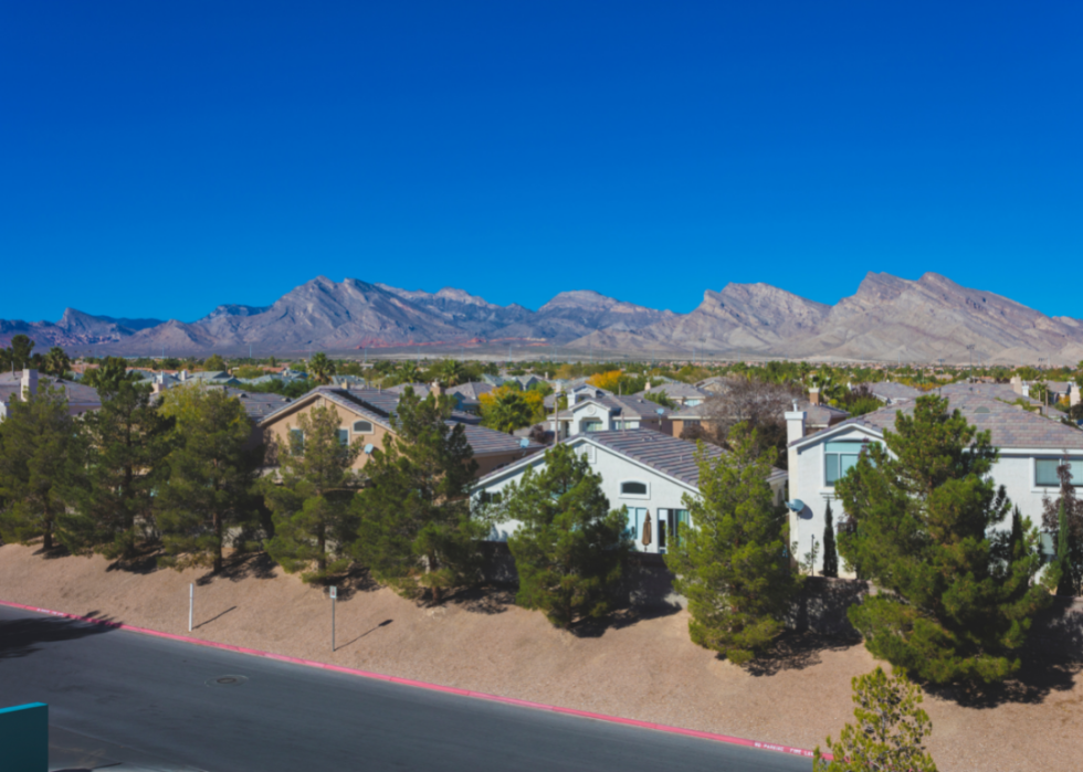 Tree-lined homes in front of mountain landscape in Nevada.