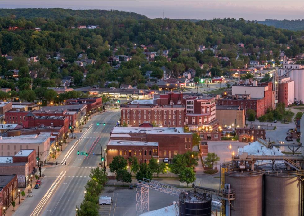 Downtown rural Minnesota at twilight with homes tucked into green hills.